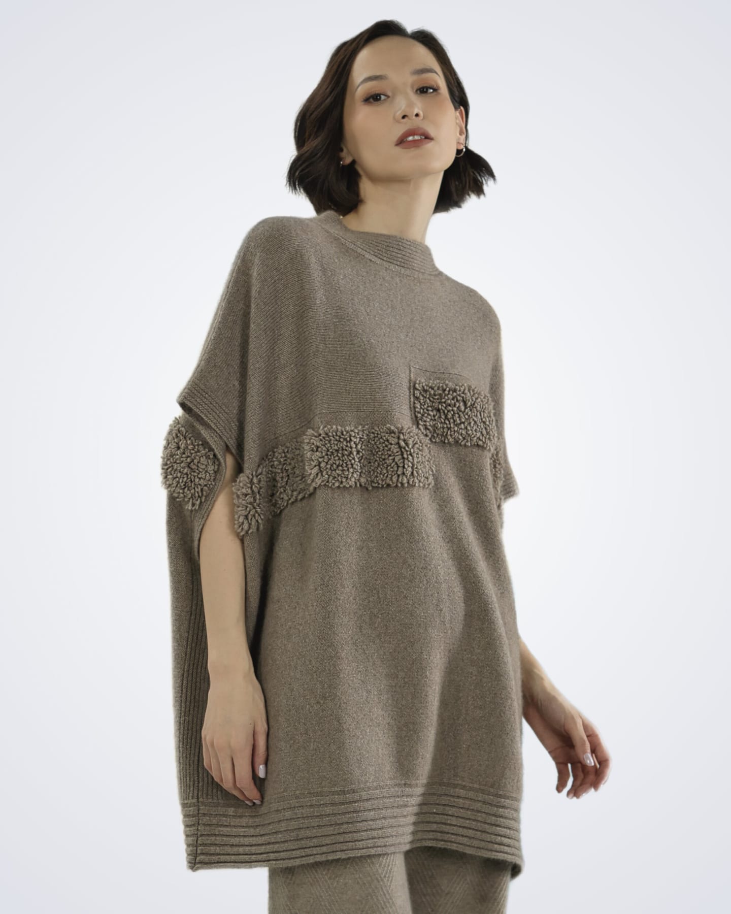 Front view of model wearing Unur's natural brown cashmere cape top with boucle panels
