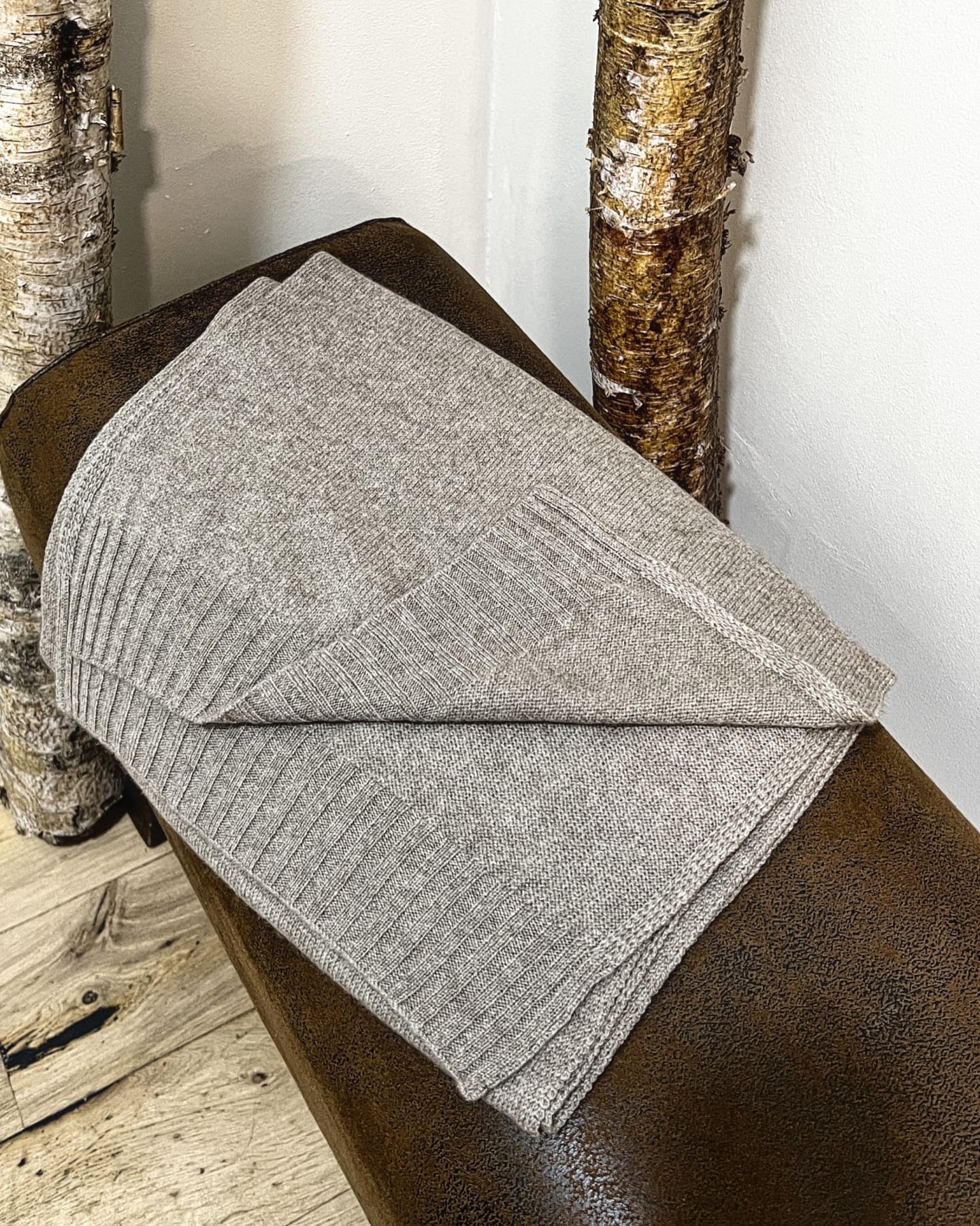 Natural brown cashmere shawl on neutral background, flat view