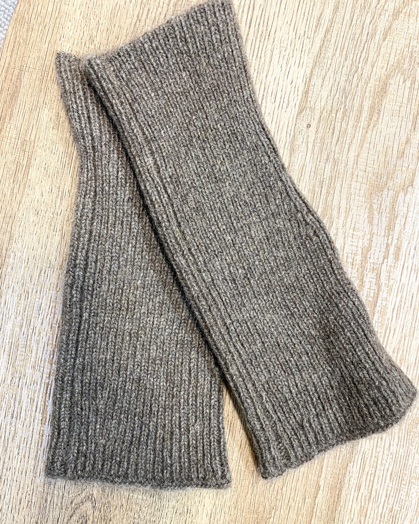 Brown yak wool hand warmers on neutral background, flat view