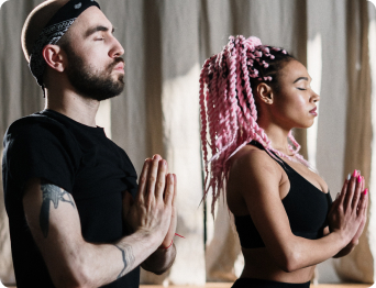 Man in black tank top and woman in black tank top Meditate