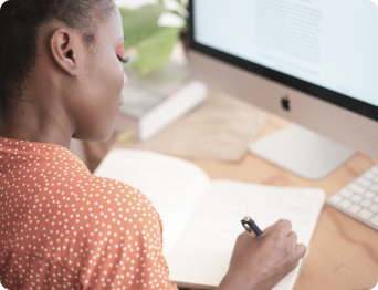 woman writing on her notebook
