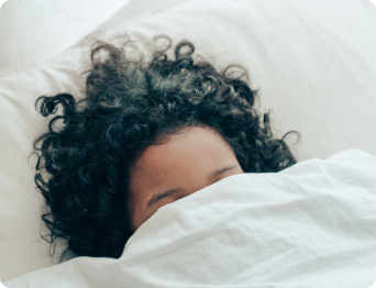 person sleeping under blanket