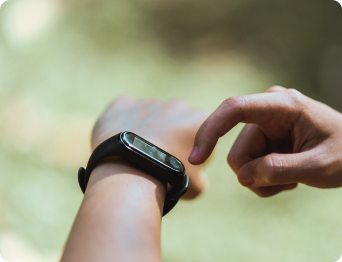 person using smart watch outdoors