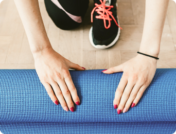 young sportswoman unfolding sport mattress