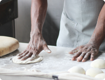 man preparing dough for bread