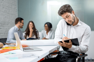 Man holding phone between neck and shoulder; an example of bad posture in the office