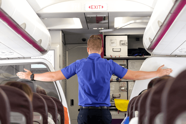 Male flight attendant demonstrating confident hand positioning