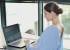 Woman working at her laptop with Upright device on her upper back