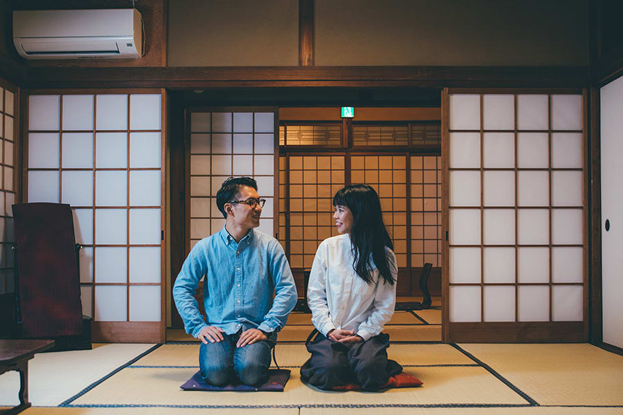 Man and woman sitting on the floor in Japan