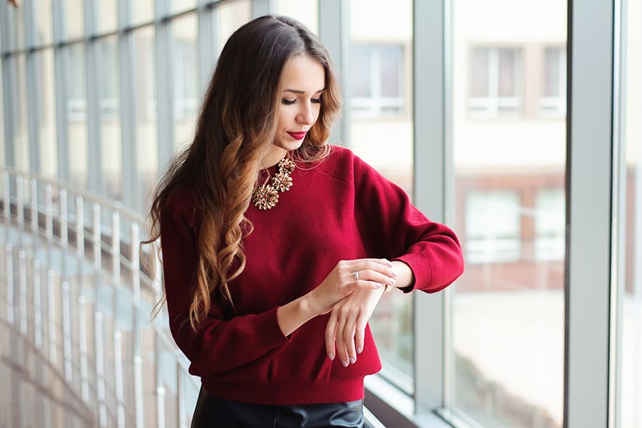 Woman looking at her watch - Do Posture Correctors Work?