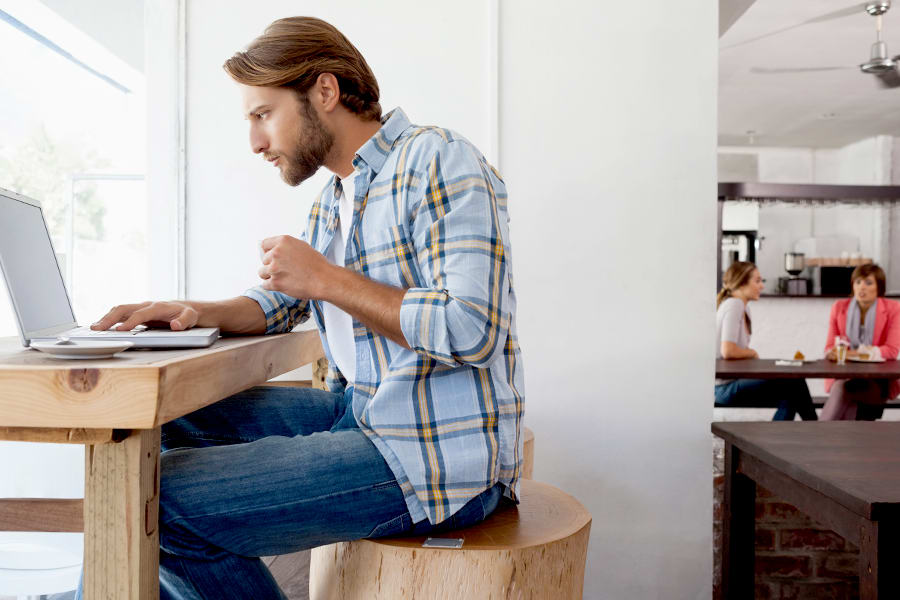 Man hunched over his laptop.