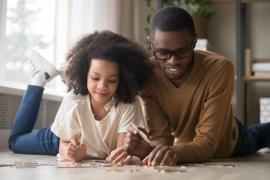 Father and daughter playing on the floor