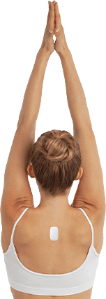 Woman stretching her arm above her head with Upright Go on her upper back