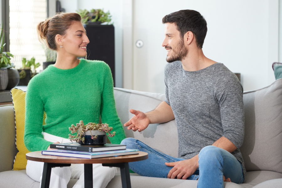 ouple sitting on couch displaying the body language of love