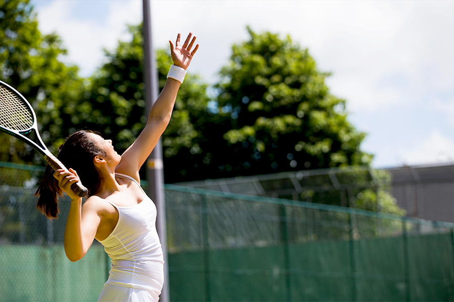 Female tennis player mid-swing