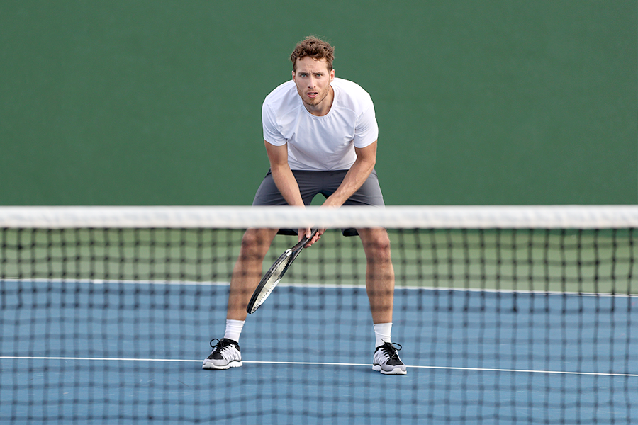 Player with poor tennis posture in ready position