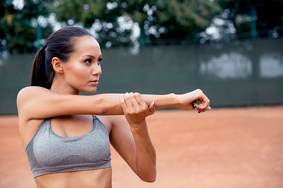 Female athlete doing upper-body stretches