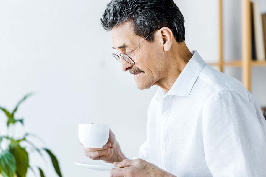 Elderly man demonstrating stooped posture with rounded shoulders and forward head position
