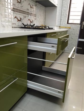 Green Shaded Modular Kitchen With White Counter Top And Olive