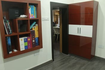 Bedroom With Wooden Wall Shelves And Glass Finish Wooden