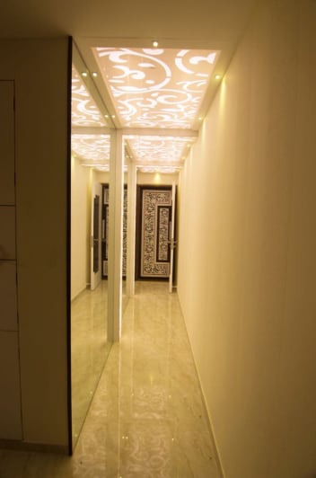 Mirror Walled Hallway With Glossy Tiled Floors And Carved