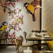 Restaurant With Wooden Table And Cushioned Chairs And Vibrant Wall Art by Nishtha Nayyar Modern | Interior Design Photos & Ideas