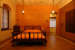 Simple Bedroom With Shades Of Orange And Wooden Wardrobe by HEJC Architects Combine Bedroom Eclectic | Interior Design Photos & Ideas