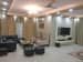Spacious Living Room with Black L Shape Sofa Set and Beige Morgan Chairs by Ar. Barkha Jain Living-room Modern | Interior Design Photos & Ideas