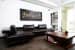 Black Sectional Sofa And Brown Wooden Table by Yogesh Goel Living-room | Interior Design Photos & Ideas