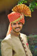 Handsome Groom With Red And Golden Turban with Brooch by Vaibhav Mandrekar Groom-wear-and-accessories | Weddings Photos & Ideas