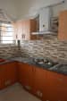 L shape kitchen with window and cabinets and wall decor by Jagan Modular-kitchen Modern | Interior Design Photos & Ideas