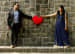 Bride and Groom To-Be Pose With a Red Heart-Shaped Pillow by Rushil Jadhav Wedding-photography Groom-wear-and-accessories Wedding-dresses | Weddings Photos & Ideas