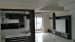 B/W themed kitchen with white glossy cabinets and black wooden panels by Ritesh Aradhana Sultania Modular-kitchen Modern | Interior Design Photos & Ideas