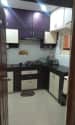 Brown L shaped kitchen with cabinets by Shiva Interiors Modular-kitchen Minimalistic | Interior Design Photos & Ideas