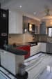 U shaped kitchen with modern cabinets and wall decor by Prashant Mali Modular-kitchen Contemporary | Interior Design Photos & Ideas