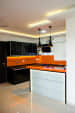 Stylish Open Island Modular Kitchen With Black Cabinets and Orange Walls by Tarun Chaudhary Modular-kitchen Modern | Interior Design Photos & Ideas