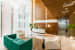 Office Reception With Coral Green Tuxedo Sofa And Brown Carpet by narayan moorthy Modern | Interior Design Photos & Ideas