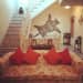 Living room with floral patterned couch and bright orange plush pillow by The Kotri Living-room Traditional | Interior Design Photos & Ideas
