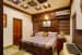 Wooden King Size Bed with Wooden Wall along with Wall Art by Monnaie Architects Bedroom Contemporary | Interior Design Photos & Ideas