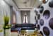 Compact Living Room with Black L Shaped Sitting Space and Circular Wall Art by Monnaie Architects Living-room Modern | Interior Design Photos & Ideas
