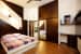 Low Top King Size Bed with Wooden Sliding Wardrobe and Wood Flooring by Monnaie Architects Bedroom Contemporary | Interior Design Photos & Ideas