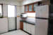 Open peninsula kitchen with brown cabinet by K D Mistry Interior Modular-kitchen Modern | Interior Design Photos & Ideas