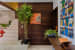 Peppy Orange Wall Art on Walnut Brown Wooden Wall with House Plant on Staircase by Dhaval Patel Indoor-spaces Contemporary | Interior Design Photos & Ideas