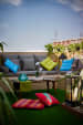Grey Couch with Colorful Cushions and Synthetic Turf on Floor by Dhaval Patel Open-spaces Contemporary | Interior Design Photos & Ideas