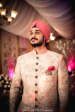 Soft Pink Flower Printed High Collared Sherwani With Black Circular Buttons And Pink Pocket Square by Gautam Khullar Groom-wear-and-accessories | Weddings Photos & Ideas