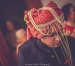 Candid Shot Of The Groom In A Red Safa With Golden Detailing And Pearls by Gautam Khullar Wedding-photography Groom-wear-and-accessories | Weddings Photos & Ideas