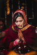 Perfectly Capturing The Bride During Rituals With Gold Jewellery And A Red Wedding Outfit by Gautam Khullar Wedding-photography Bridal-jewellery-and-accessories | Weddings Photos & Ideas