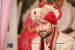 Red And Golden Silk Turban With Red Gem Brooch by Akshat Mongia Groom-wear-and-accessories | Weddings Photos & Ideas