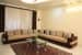 Chocolate brown and beige L shaped sectional sofa and glass top center table by Sudeep S Gandhi ID Living-room Contemporary | Interior Design Photos & Ideas