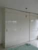 White glossy hinged standing wardrobe with white ceiling by Sudeep S Gandhi ID Bedroom Minimalistic | Interior Design Photos & Ideas